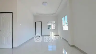 Spacious and bright empty room with large windows and glossy tiled floor, perfect for customization.