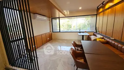 Modern living room with large window and stylish furniture