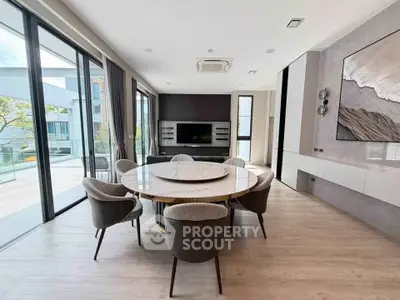 Luxurious modern dining room with large windows and elegant decor