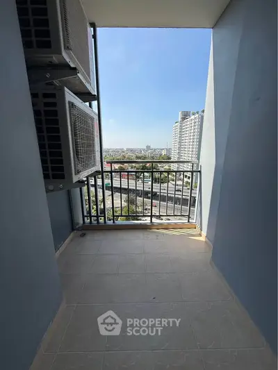 Spacious balcony with city view in modern high-rise apartment