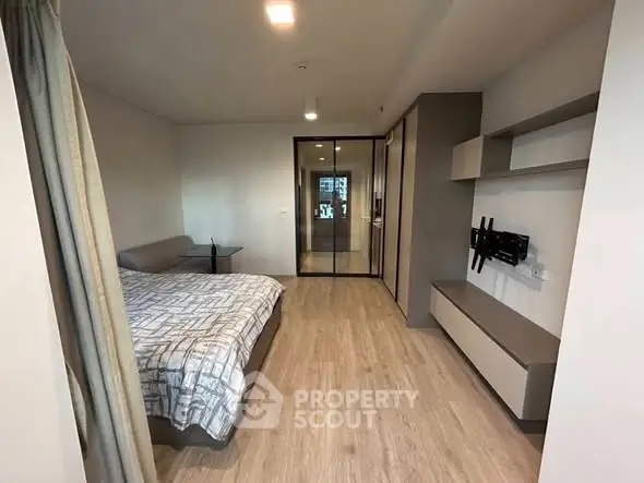 Modern bedroom with sleek design and ample storage in a contemporary apartment.