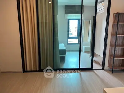 Modern apartment interior with sliding glass doors and natural light