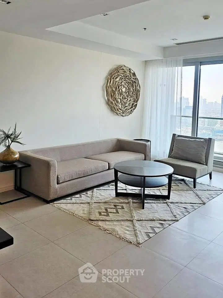 Modern living room with stylish decor and city view, featuring a cozy sofa and elegant coffee table.