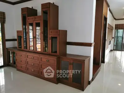 Spacious living room with elegant wooden cabinetry and polished floors