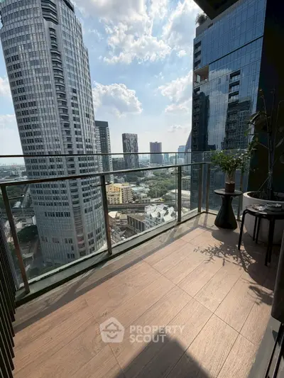 Stunning city view from modern high-rise balcony with sleek glass railing.