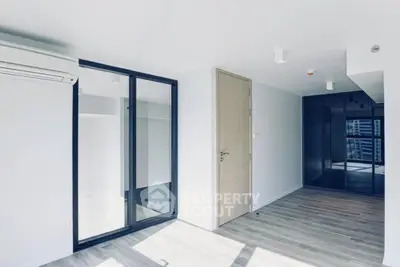 Modern minimalist apartment interior with sleek design and ample natural light.