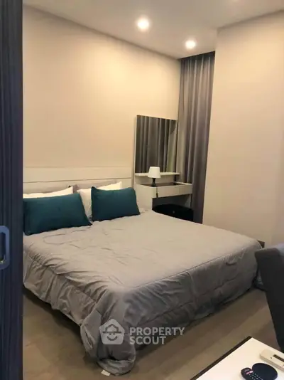 Cozy bedroom with modern decor and soft lighting, perfect for relaxation.