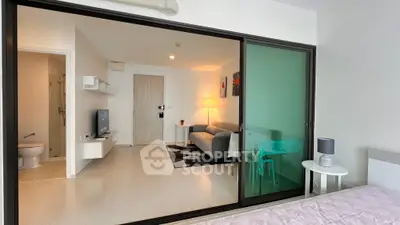 Modern apartment interior with sliding glass doors and cozy living area