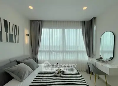Modern bedroom with stylish decor, large window, and elegant curtains in a bright apartment.