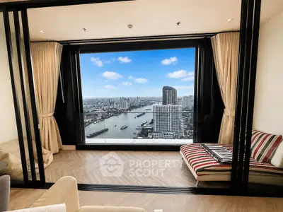 Luxurious living room with stunning city and river view from high-rise apartment.