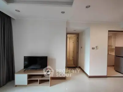 Modern living room with TV and open kitchen in stylish apartment