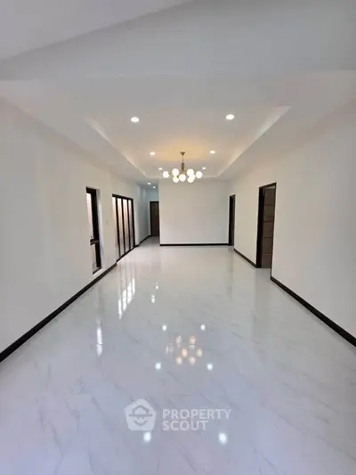 Spacious modern living room with elegant lighting and glossy flooring