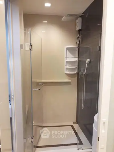 Modern bathroom with glass shower enclosure and sleek fixtures