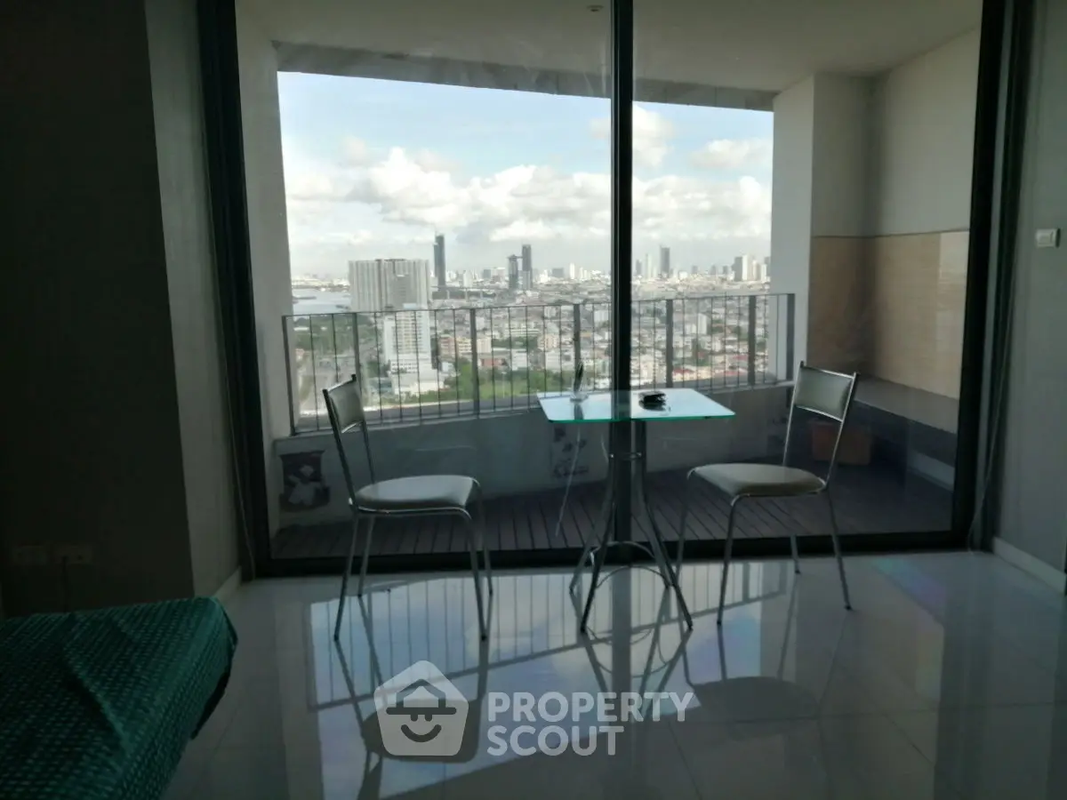 Modern apartment with stunning city view from balcony, featuring sleek glass doors and minimalist furniture.