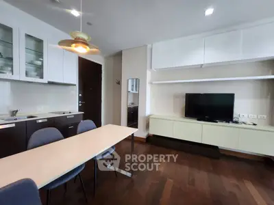 Modern living room with sleek furniture and open kitchen layout, perfect for urban living.