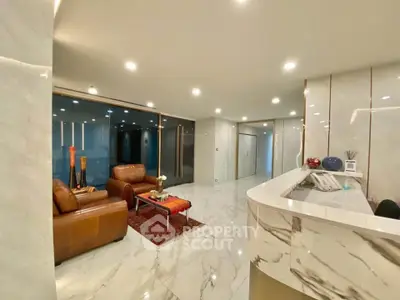 Luxurious marble-floored living room with leather sofas and modern decor