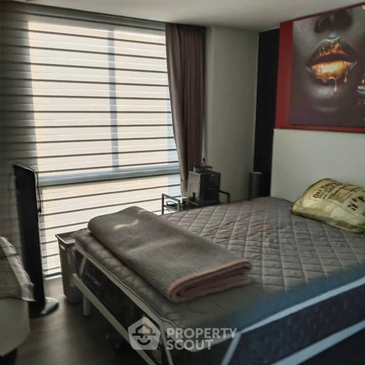 Cozy bedroom with modern decor and large window for natural light