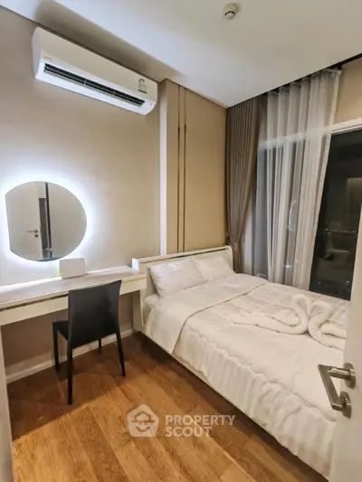 Cozy bedroom with modern decor, featuring a comfortable bed and stylish vanity area.
