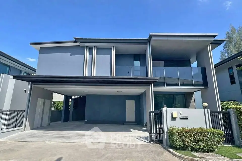 Modern two-story house with sleek design and spacious driveway in a serene neighborhood.
