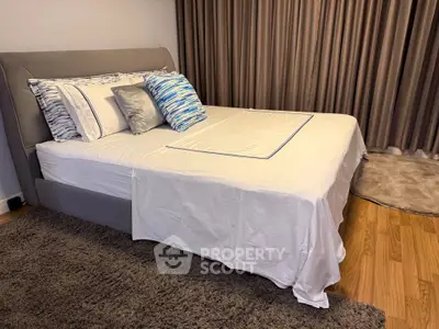 Elegant bedroom with plush bedding and stylish decor in modern apartment.