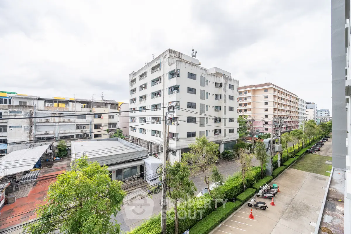 Urban residential buildings with lush greenery and clear sky view