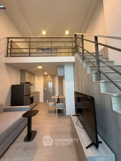 Modern loft apartment with open layout, stylish kitchen, and mezzanine level for extra space.
