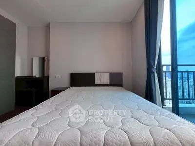 Spacious bedroom with large window and city view, featuring a comfortable bed and modern decor.