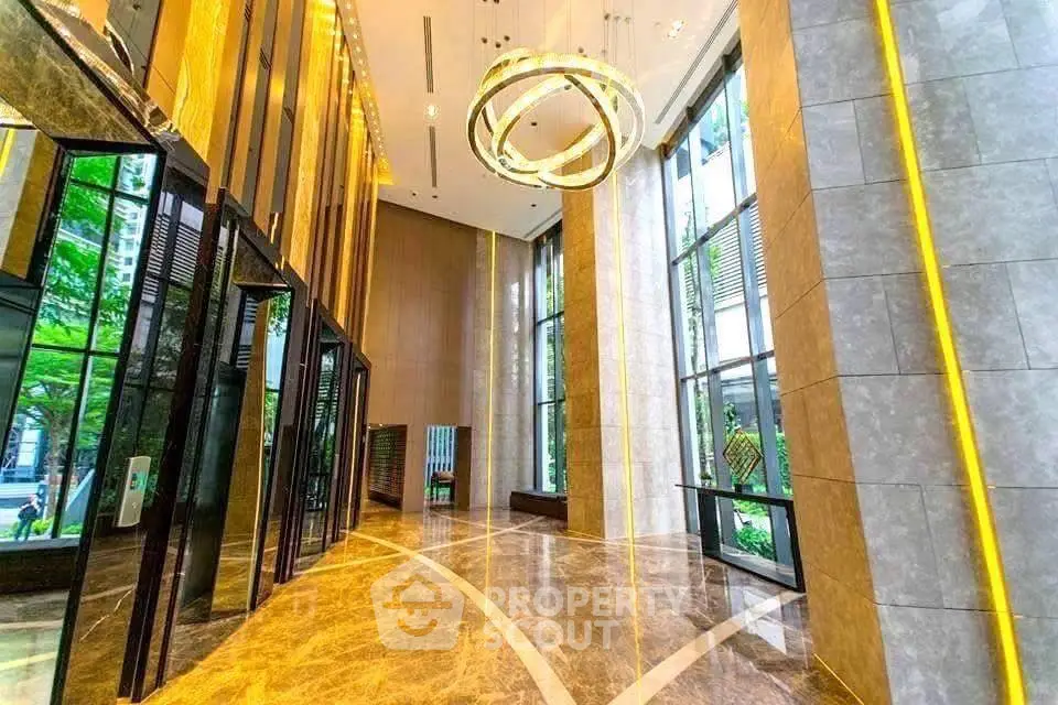 Luxurious building entrance with high ceilings and elegant lighting