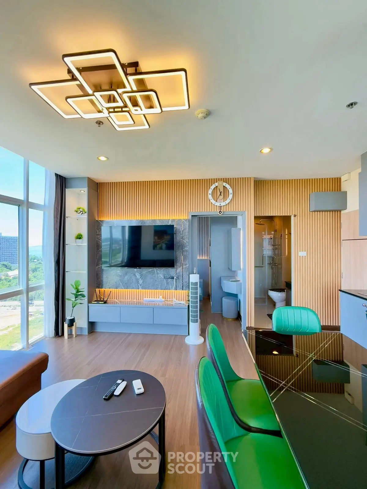 Modern living room with stylish lighting and large windows offering a scenic view.