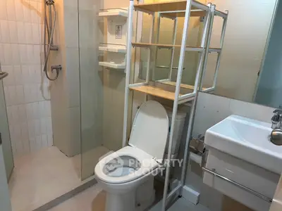 Modern bathroom with glass shower and sleek fixtures in a stylish apartment.