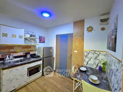 Modern kitchen with marble countertops, compact dining area, and stylish decor.