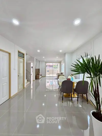 Spacious modern living room with sleek tile flooring and elegant dining area.