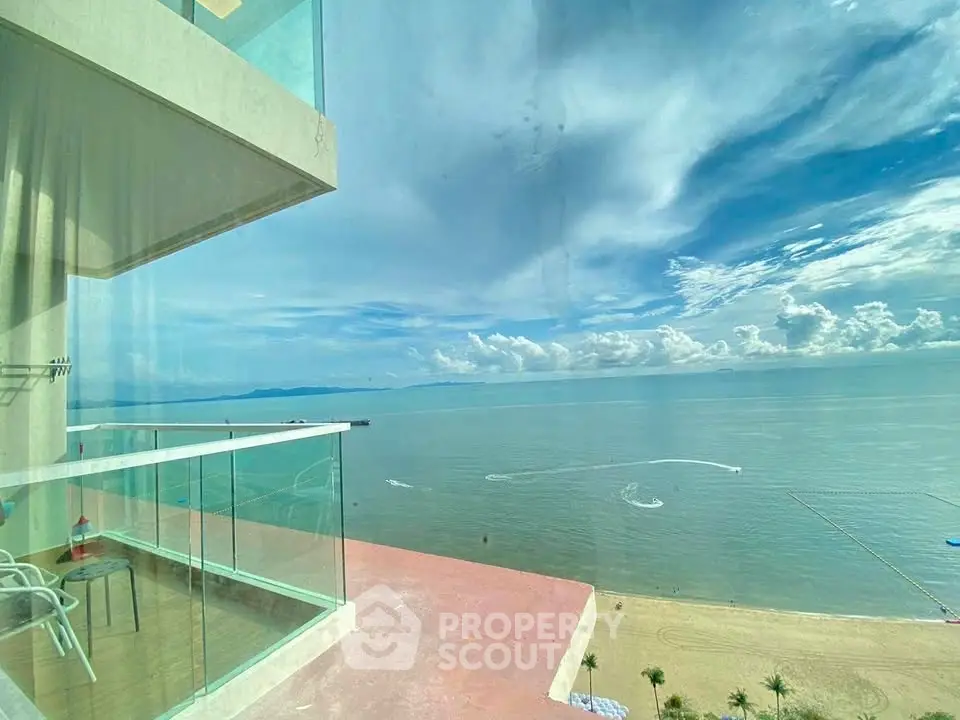Stunning ocean view from a modern balcony with glass railing, perfect for relaxation and enjoying the scenery.