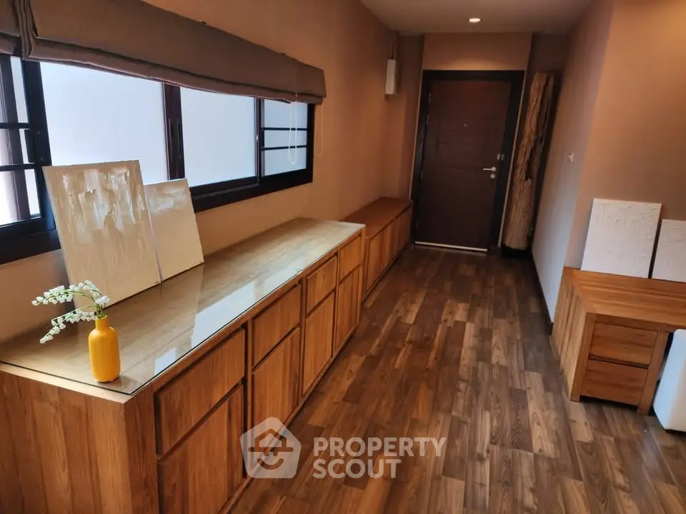 Charming hallway with wooden flooring and modern decor in a cozy home.
