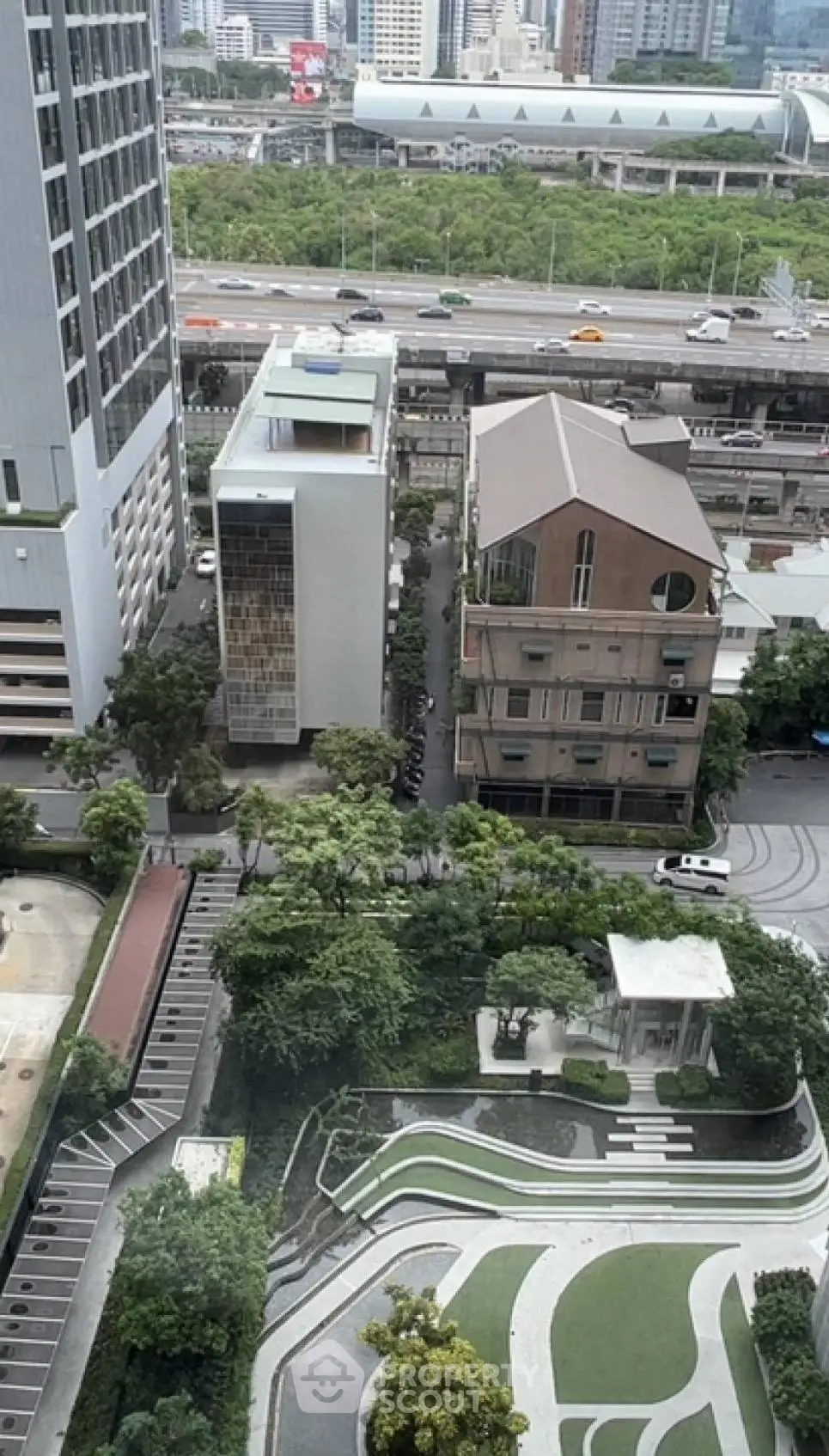 Stunning aerial view of urban landscape with modern buildings and lush greenery, perfect for city living.
