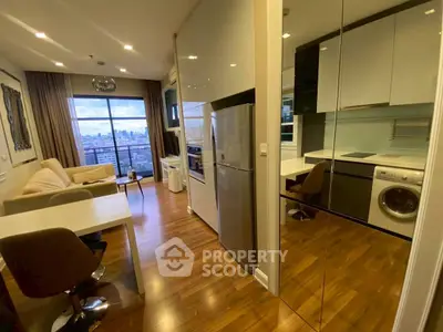 Modern apartment interior with open kitchen and city view, featuring sleek appliances and cozy living space.