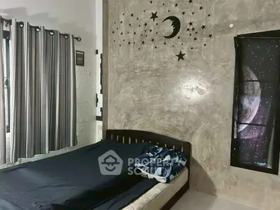 Cozy bedroom with celestial-themed decor and modern furnishings