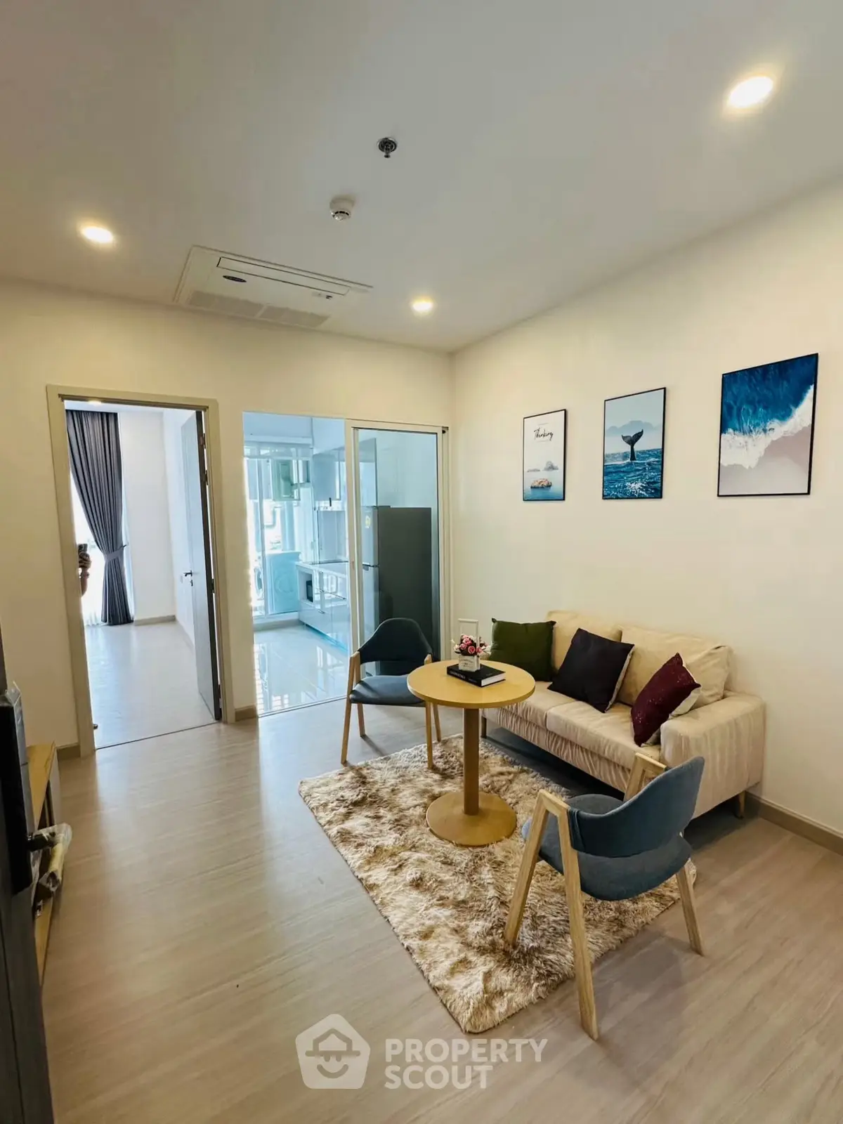 Modern living room with cozy seating and stylish decor in a contemporary apartment.