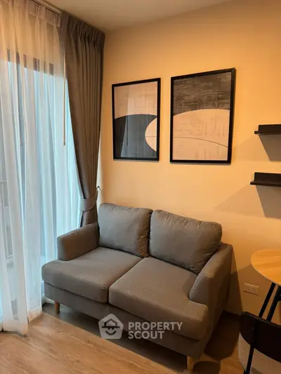 Cozy living room with modern sofa and abstract art, perfect for relaxation and style.