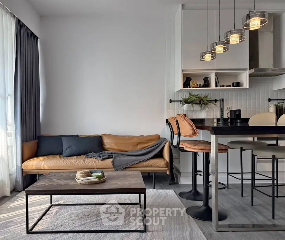 Modern living room with stylish furniture and open kitchen layout