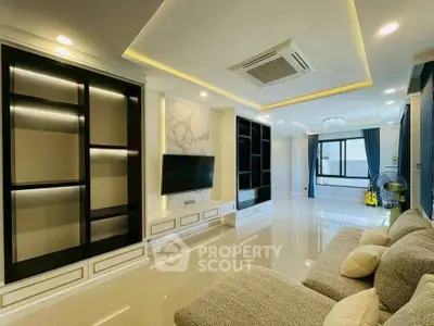 Luxurious modern living room with elegant built-in shelves and plush seating.