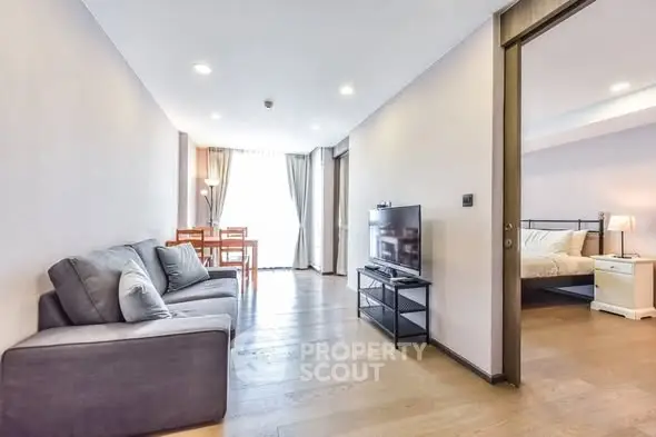 Spacious modern living room with open layout and cozy bedroom view