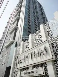 Modern high-rise building exterior with intricate facade design in Sukhumvit area.