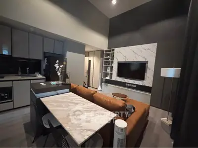 Modern living room with stylish kitchen and marble accents in open layout apartment.