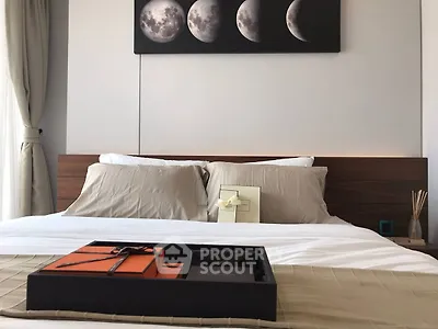 Elegant bedroom with modern decor and moon phase artwork above bed