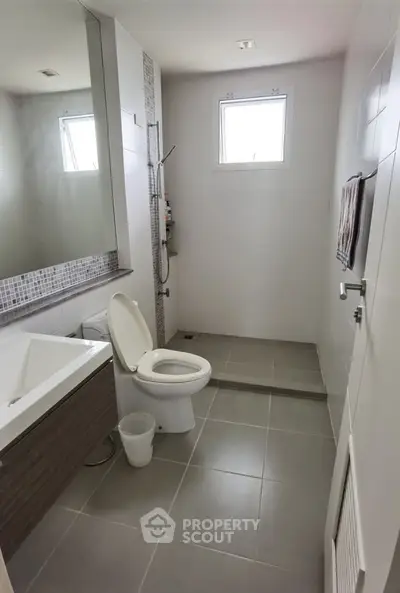 Modern bathroom with sleek design, featuring a bathtub and shower area, perfect for relaxation.