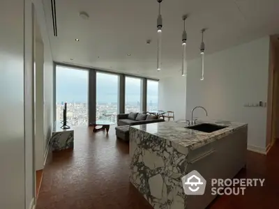 Luxurious open-layout kitchen with marble countertops and panoramic city views through floor-to-ceiling windows, complemented by modern pendant lighting.