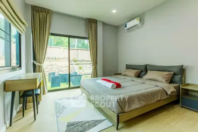 Modern bedroom with large window and stylish decor