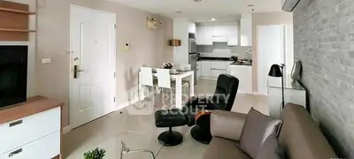 Modern open-layout living room with sleek kitchen and stylish furniture