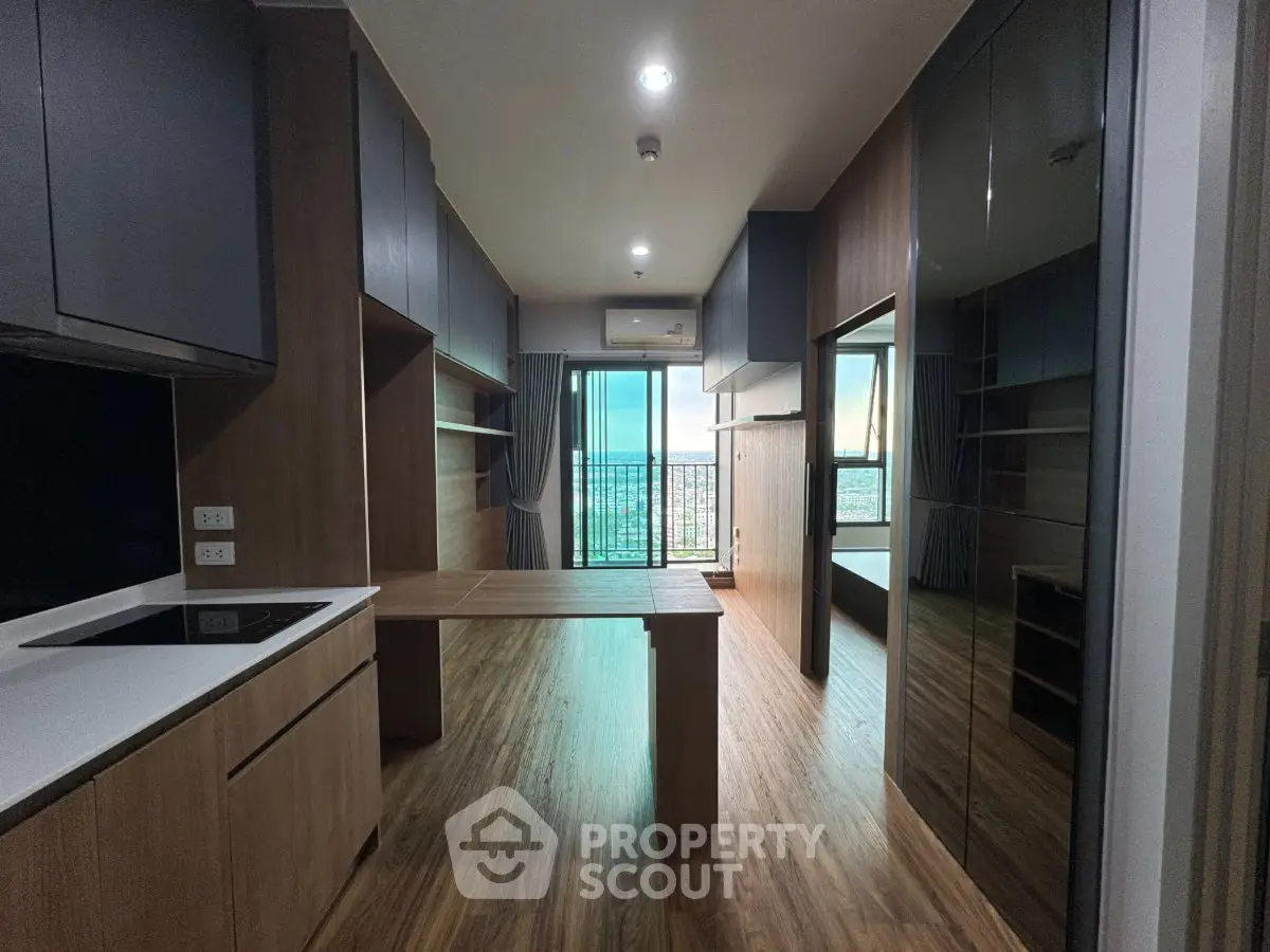Modern apartment interior with wooden flooring and open balcony view